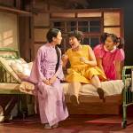 Yasuko (Phyllis Ho), Satsuki (Ami Okumura Jones) and Mei (Victoria Chen) all sitting on a hospital bed together.