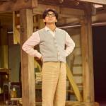 Tatsuo (Dai Tabuchi) standing with his hands on his hips in front of the house.